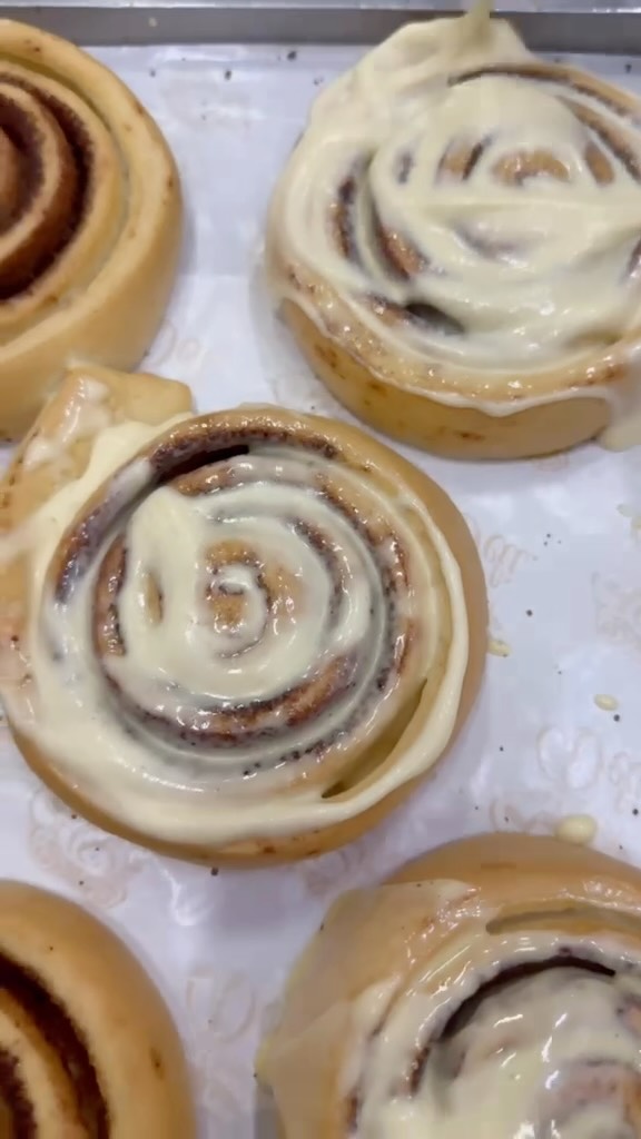 Cream cheese frosting melting into a warm roll